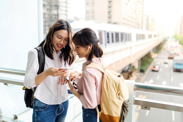 Two overseas visitors looking at a phone