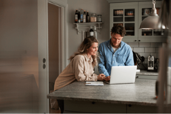 Wife and husband checking life insurance cover on their laptop