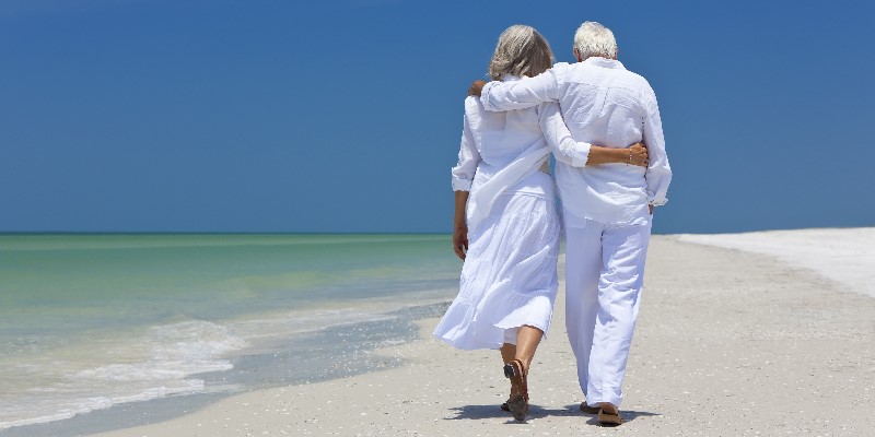 Senior couple walking on beach