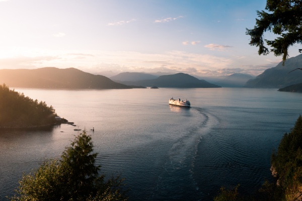 Cruise during sunset on the ocean mountains in background